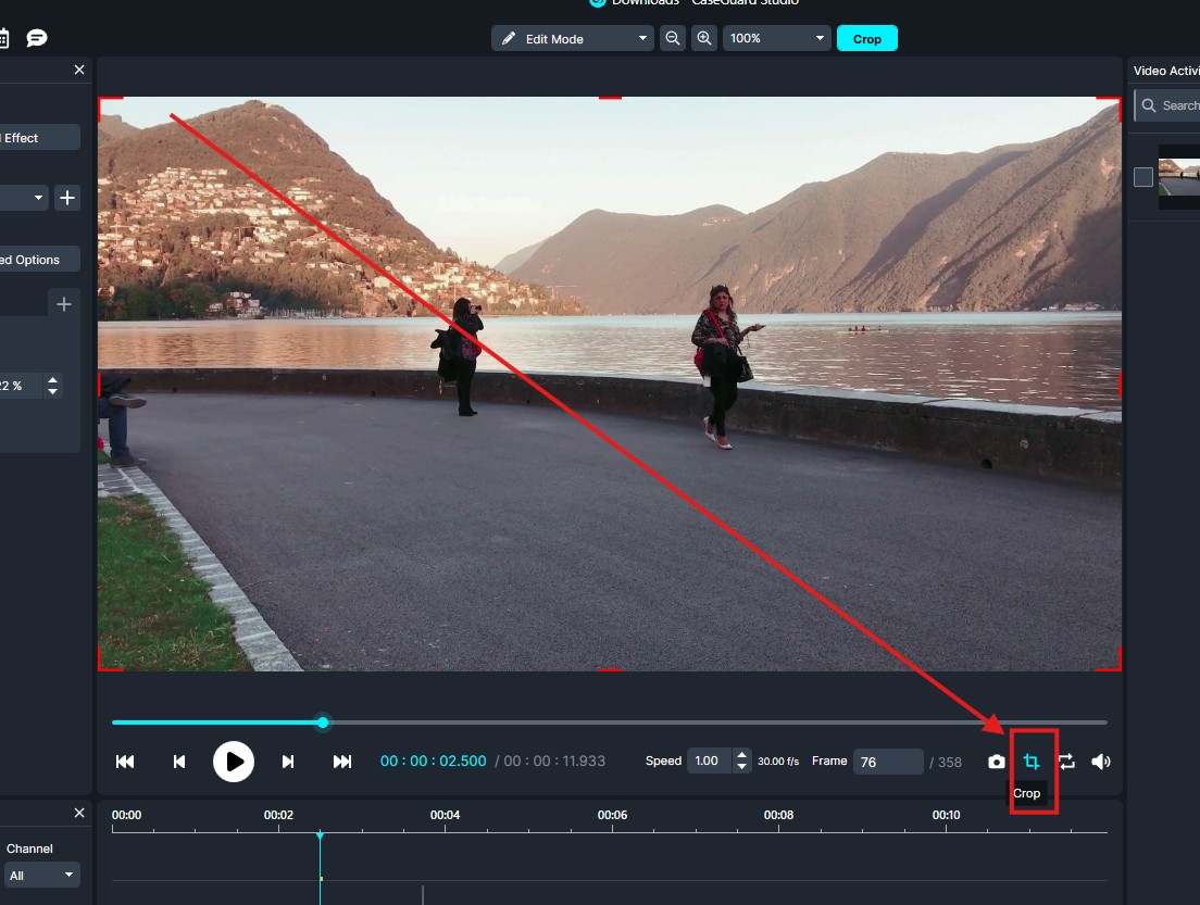 Interface of a video editor with a lakeside mountain scene; red crop guides indicate cropping the frame, with the Crop button highlighted.
