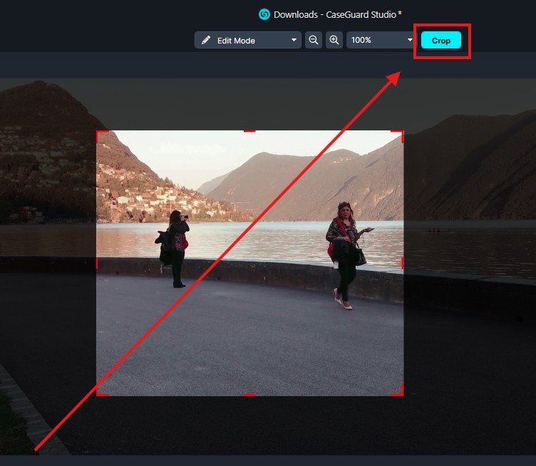 Cropping tool UI over a lakeside photo with two people; visible crop selection and a highlighted Crop button.