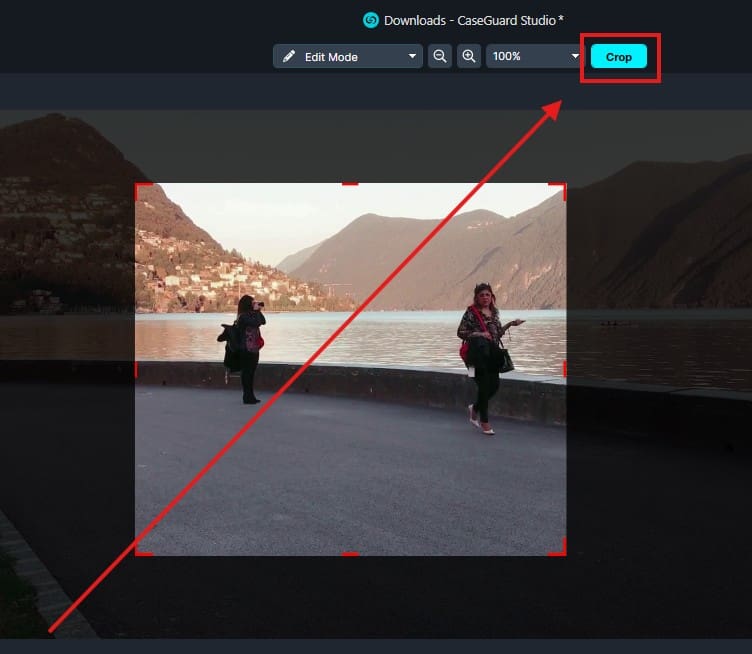 Cropping tool UI over a lakeside photo with two people; visible crop selection and a highlighted Crop button.