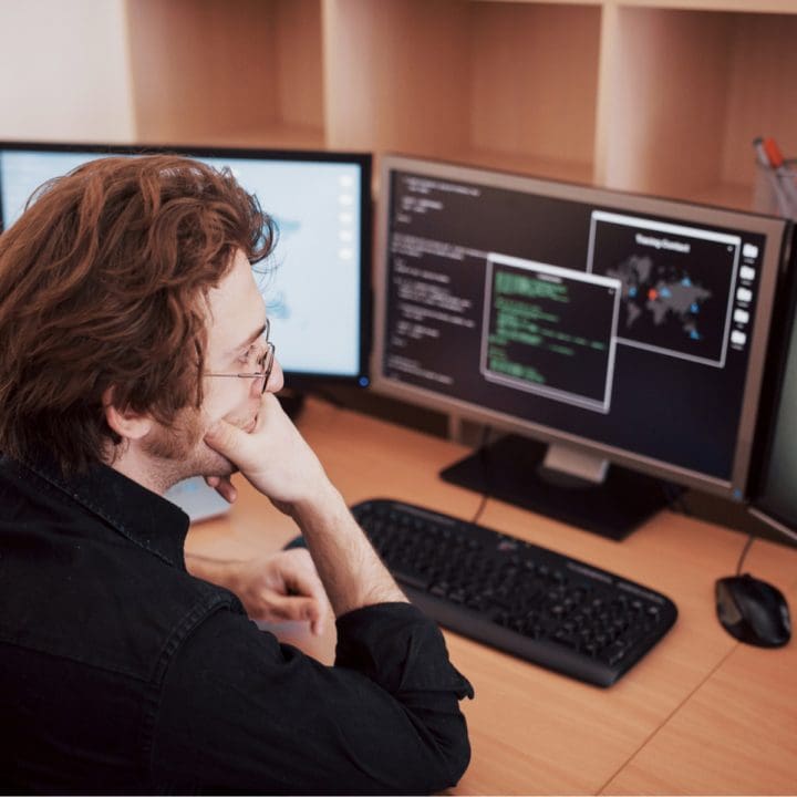 CaseGuard-male-programmer-working-on-desktop-computer-with-m-93A5TRN