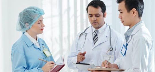 Doctors talking about a file