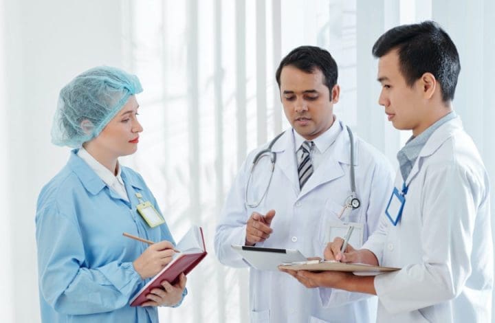 Doctors talking about a file