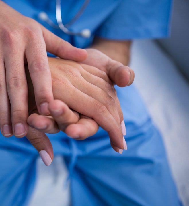 doctor-consoling-patient-in-hospital-LXWJ39K