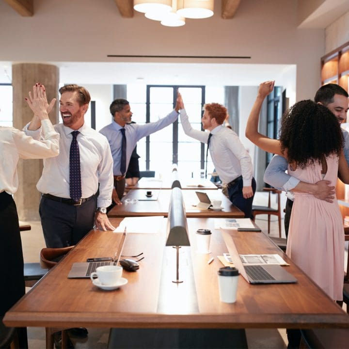 CaseGuard-six-colleagues-celebrating-success-in-an-open-plan