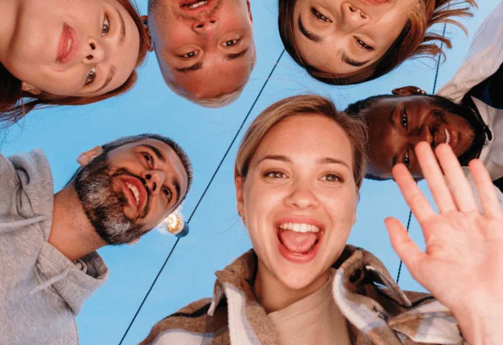 Automatic blur being applied to the faces of six people in a circle.